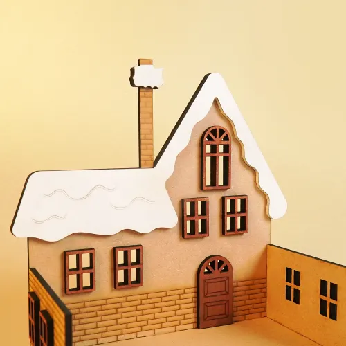 Close-up of the snow-covered wooden advent calendar house