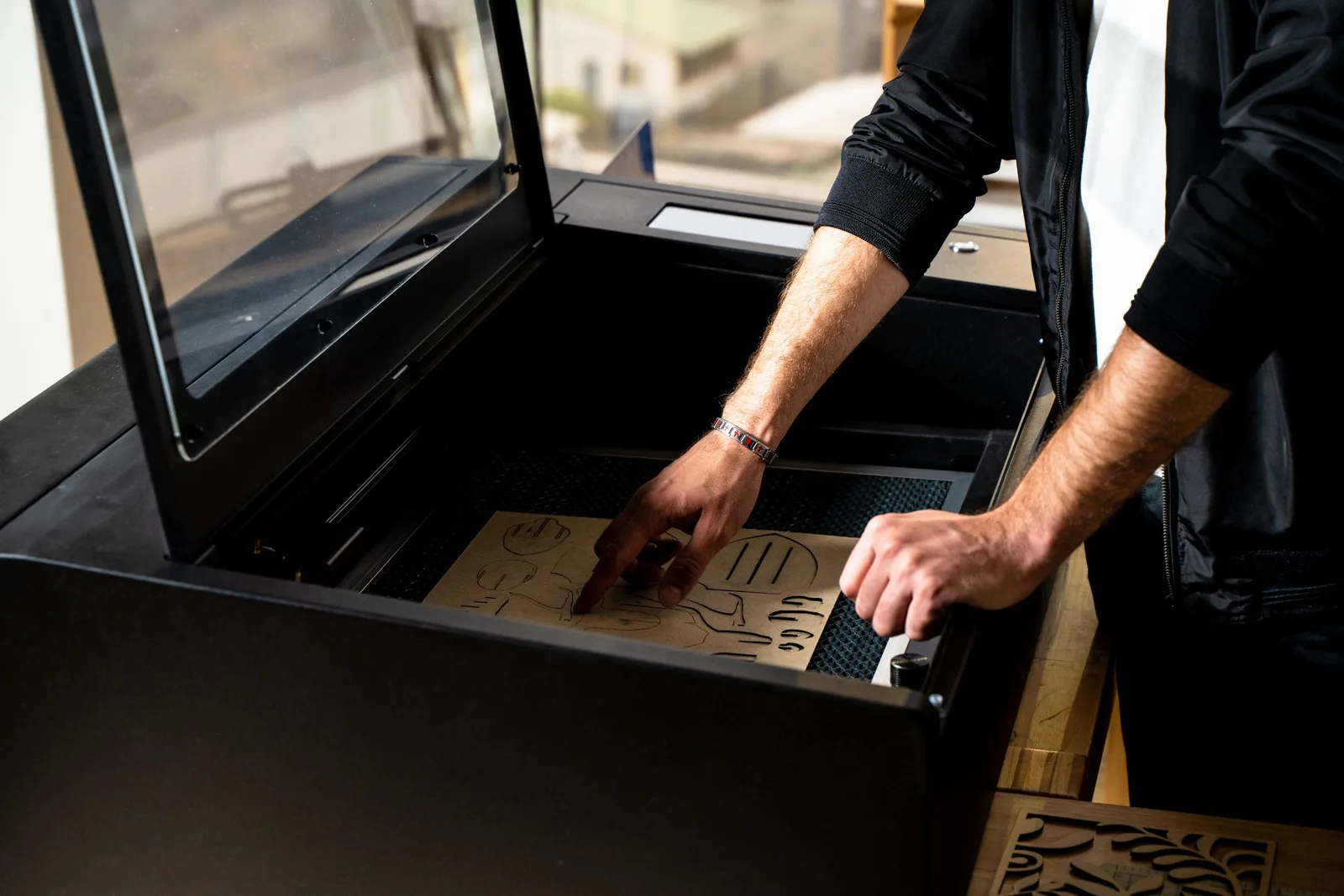 Beambox Pro laser cutter processing a wooden sheet