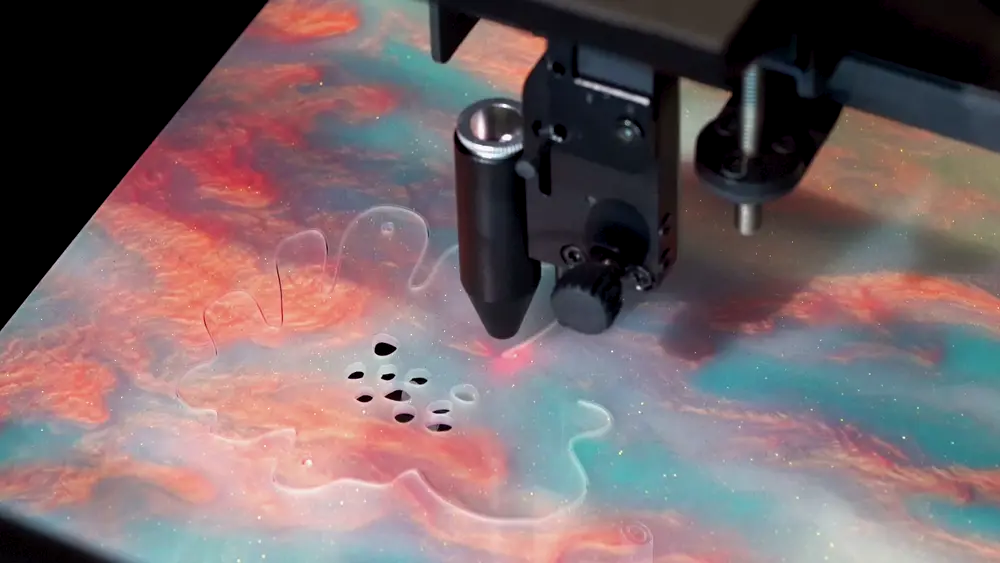 beamo II cutting a detailed design from colorful acrylic