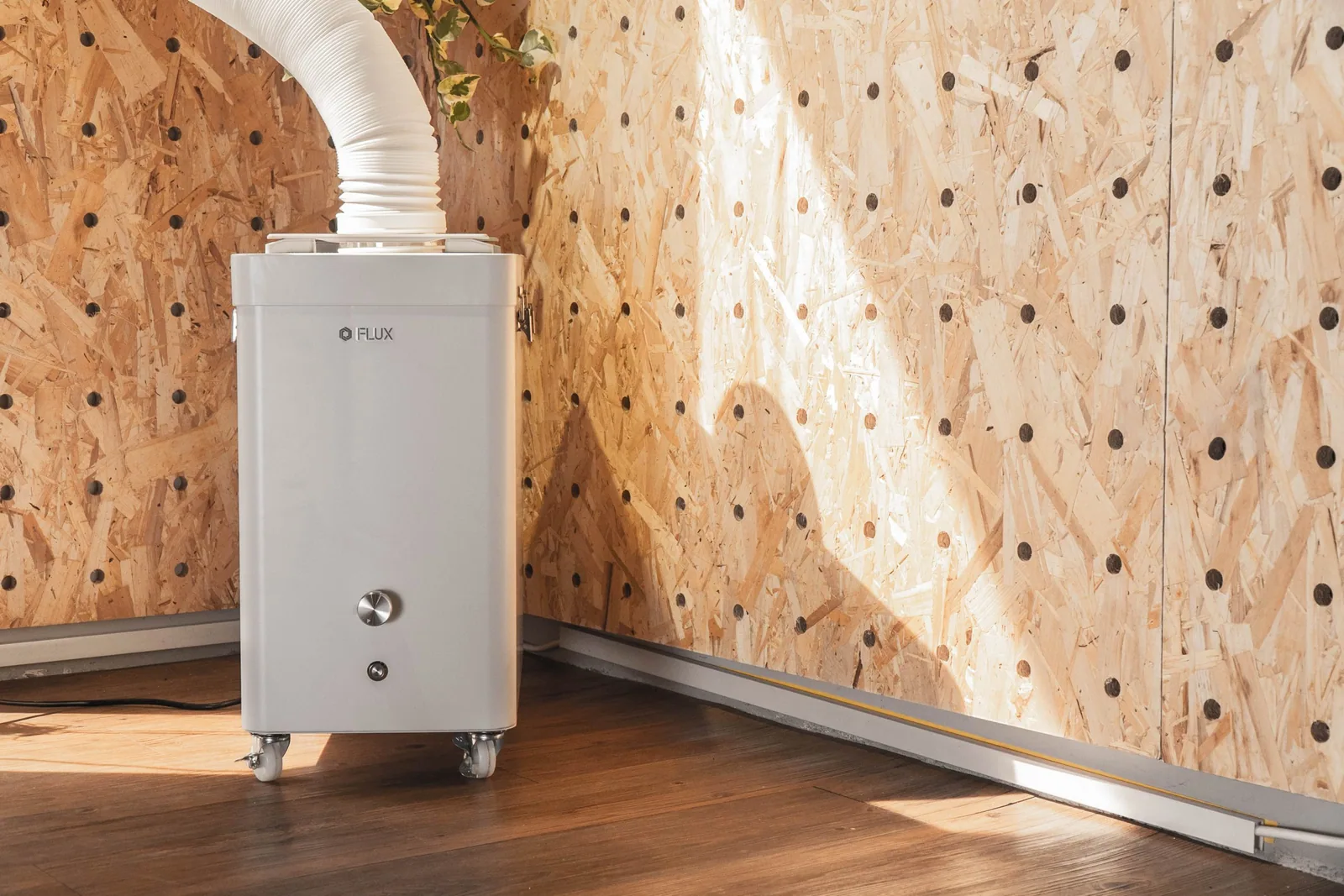 A FLUX Beam Air filter connected in a creative workspace