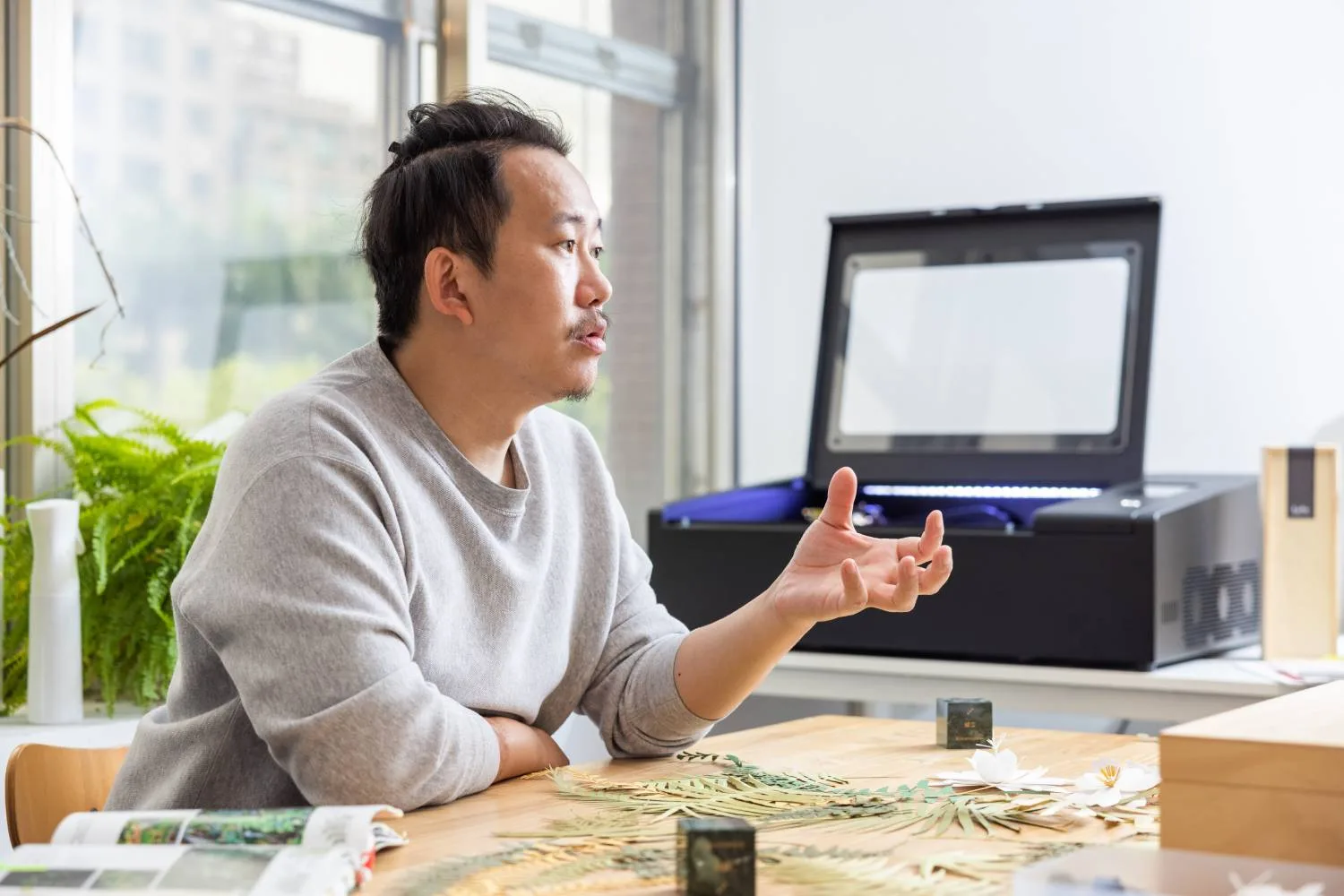 Xikai Zeng making a small model in the Studio Shikai workspace