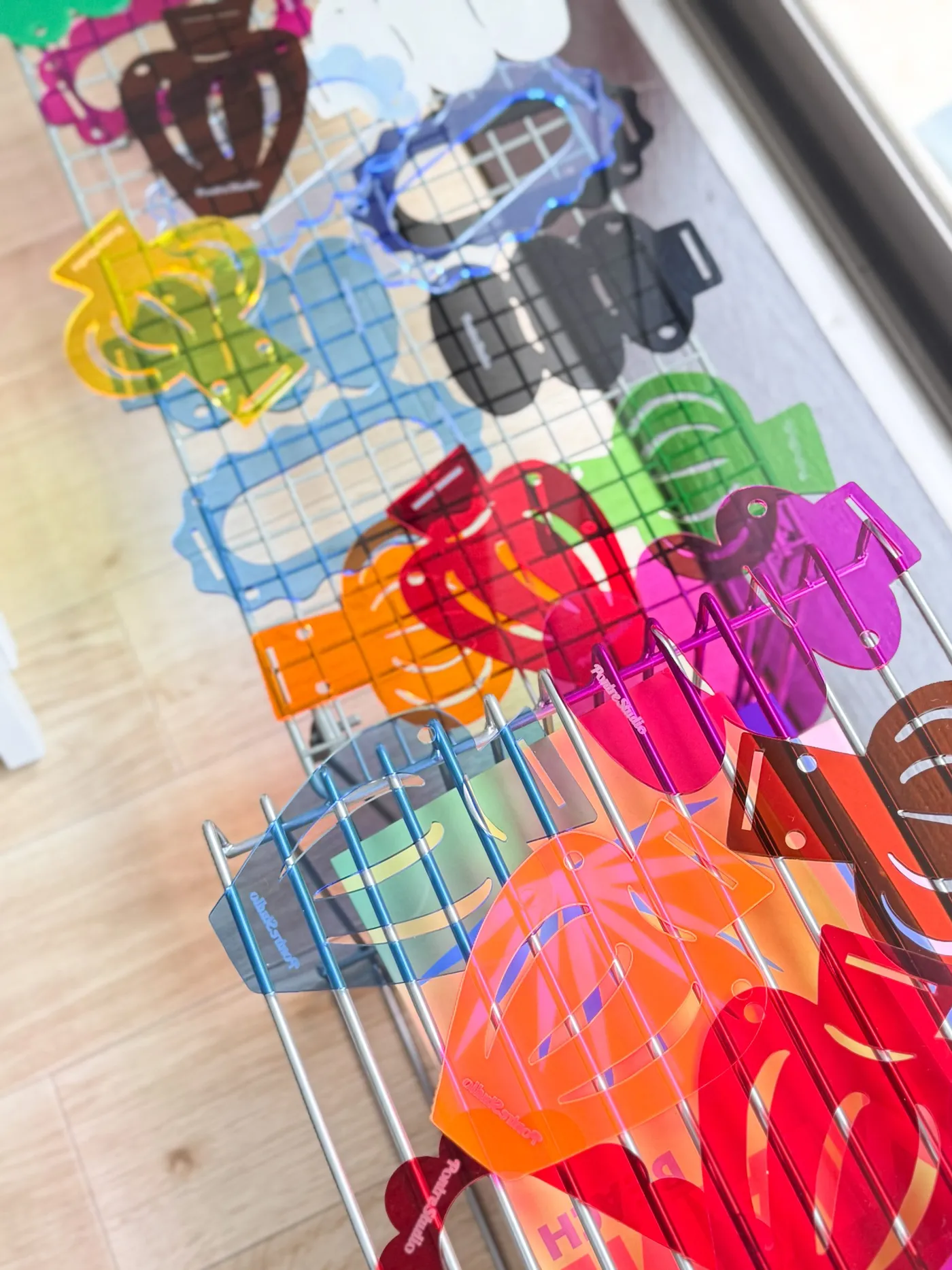 Colorful acrylic products arranged in Mika’s compact studio
