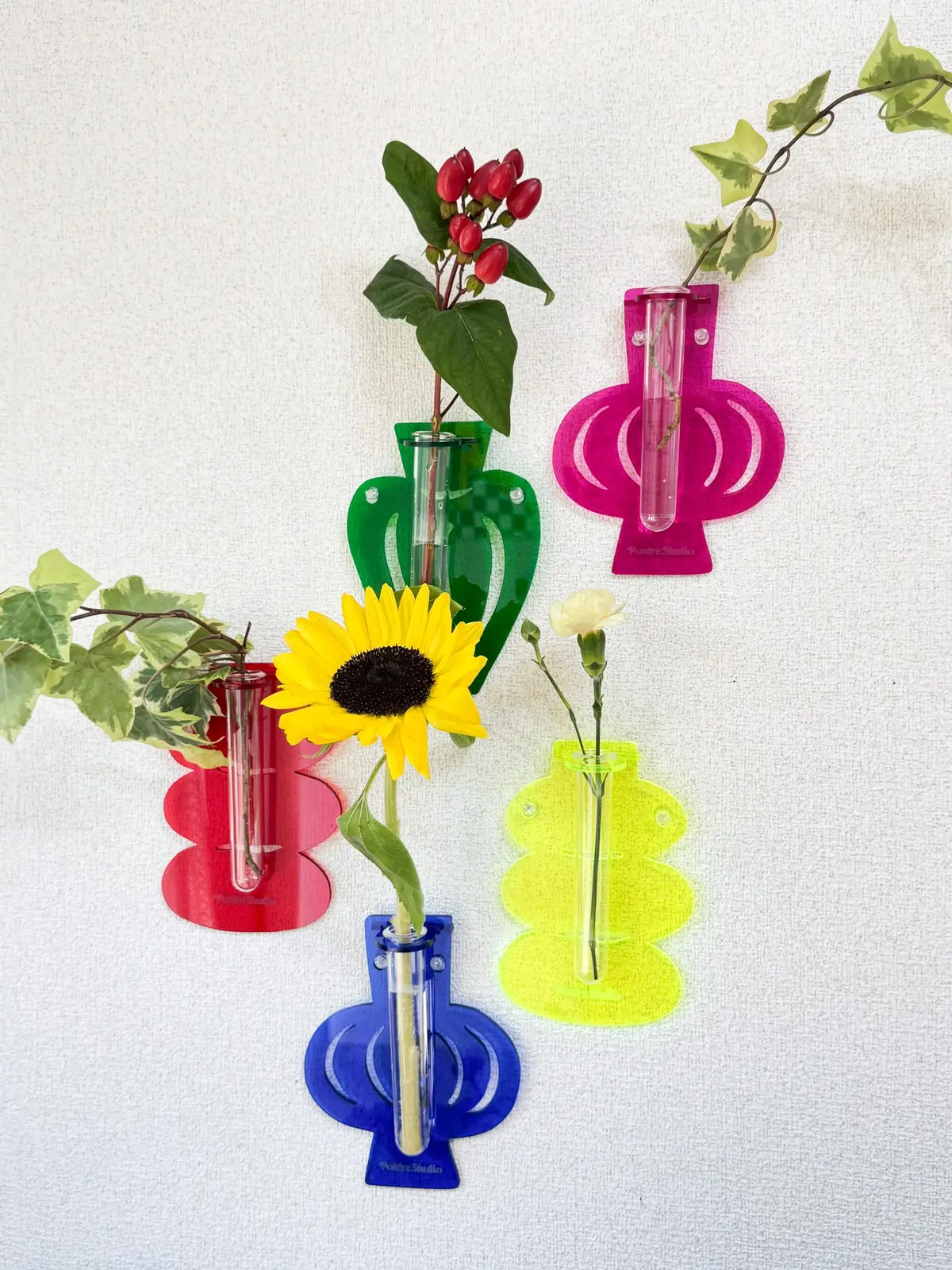 Colorful Jesmonite wall flower vases by PONTRE STUDIO