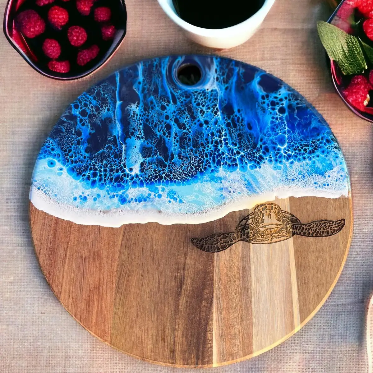 Ocean resin art layered over an engraved round wooden board