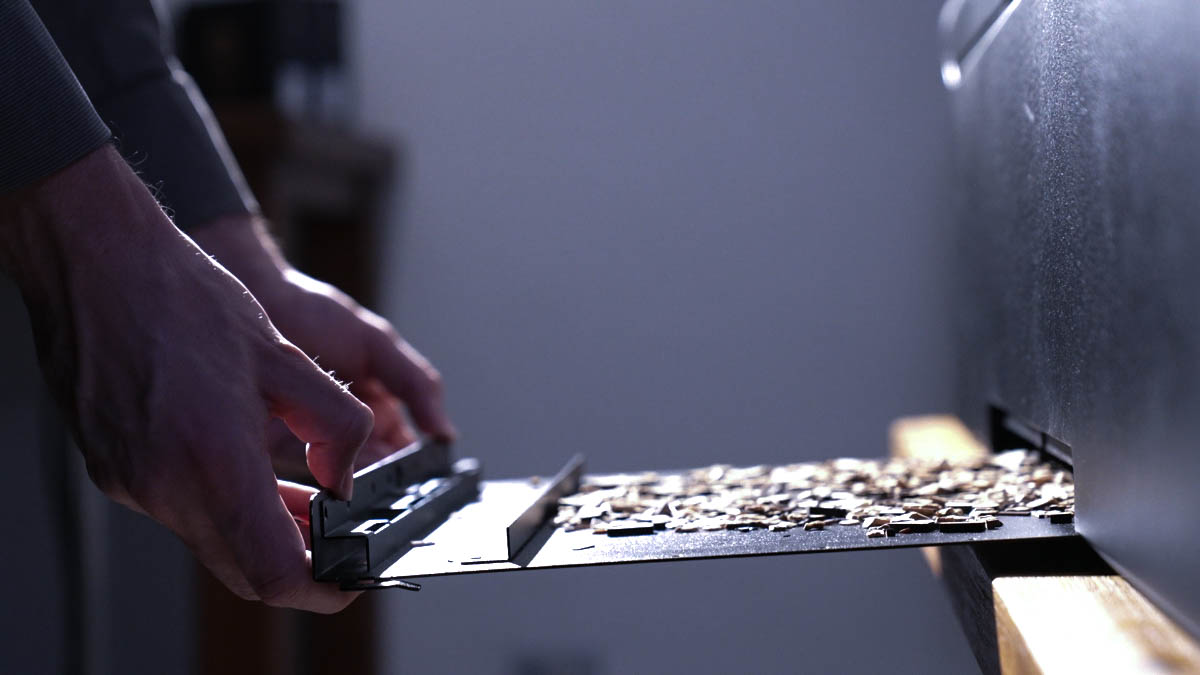 A user cleaning material remnants from HEXA through the built-in slot